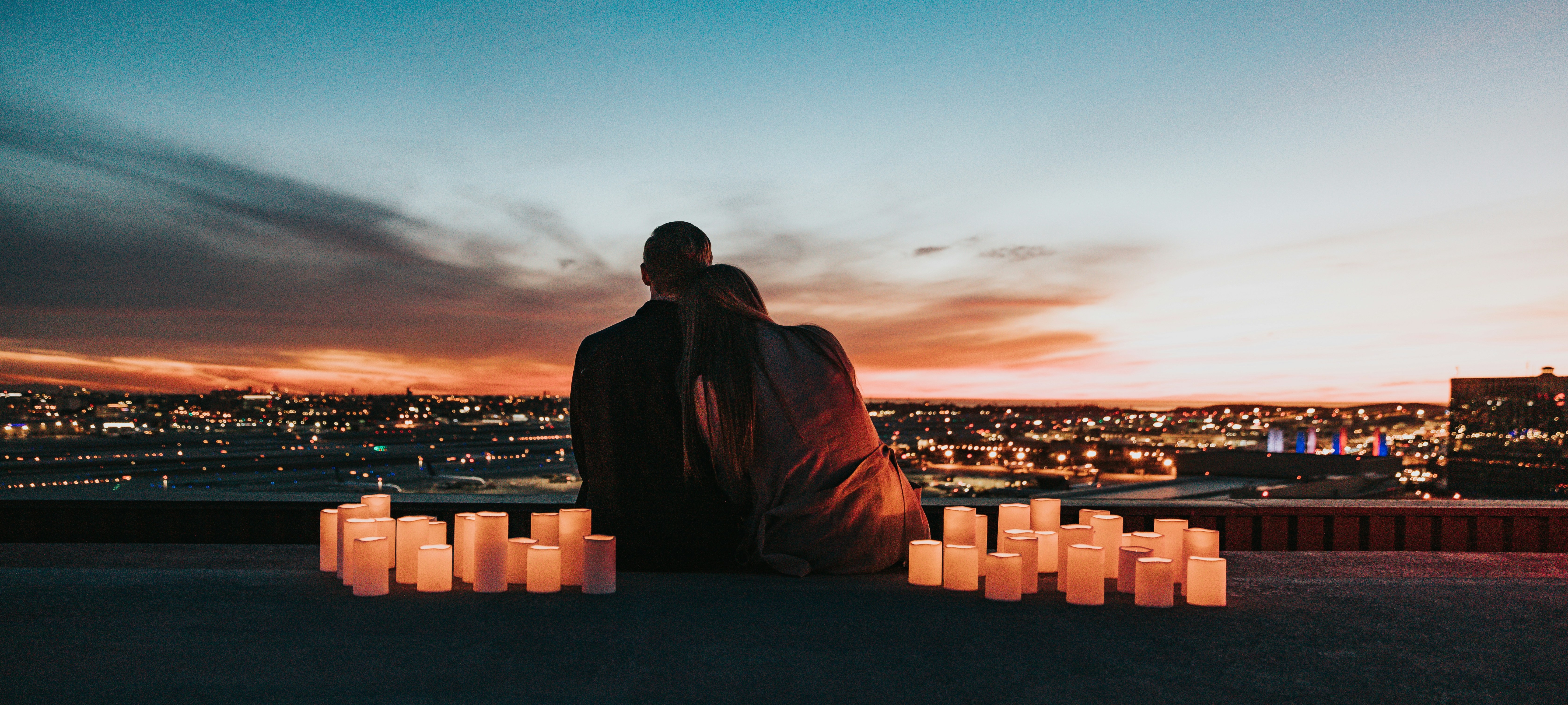 Romantic couple with candles creating intimate atmosphere